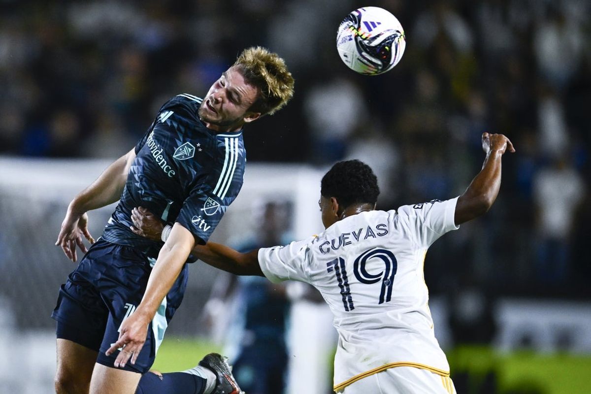 Aug 27, 2025; Carson, California, USA; Seattle Sounders FC forward Pedro de la Vega (10) heads the ball while LA Galaxy defender Maruicio Cuevas (19) defends during the first half at Dignity Health Sports Park. Mandatory Credit: Kelvin Kuo-Imagn Images