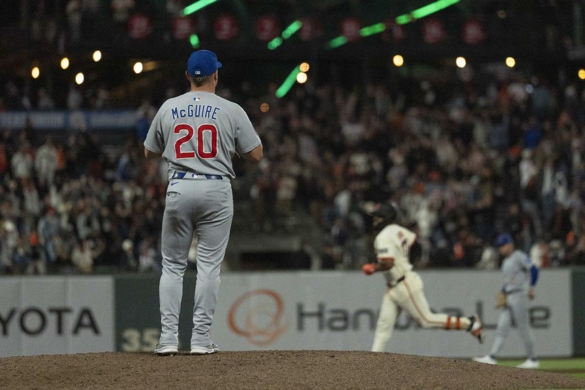 Aug 27, 2025; San Francisco, California, USA;  Chicago Cubs catcher Reese McGuire (20) watches San Francisco Giants designated hitter Rafael Devers (16) run the bases after hitting a solo home run during the eighth inning at Oracle Park. Mandatory Credit: Stan Szeto-Imagn Images