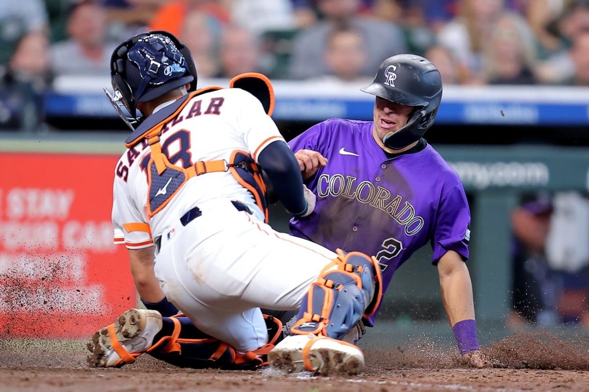 Aug 28, 2025; Houston, Texas, USA; Houston Astros catcher Cesar Salazar (18) tags out Colorado Rockies second baseman Tyler Freeman (2) as he slides into home plate during the fifth inning at Daikin Park. Mandatory Credit: Erik Williams-Imagn Images