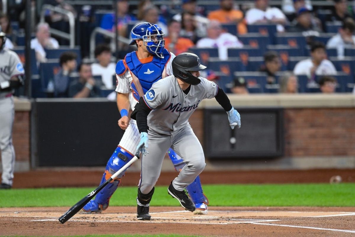Aug 28, 2025; New York City, New York, USA; Miami Marlins catcher Liam Hicks (34) hits an infield single during the first inning against the New York Mets at Citi Field. Mandatory Credit: John Jones-Imagn Images