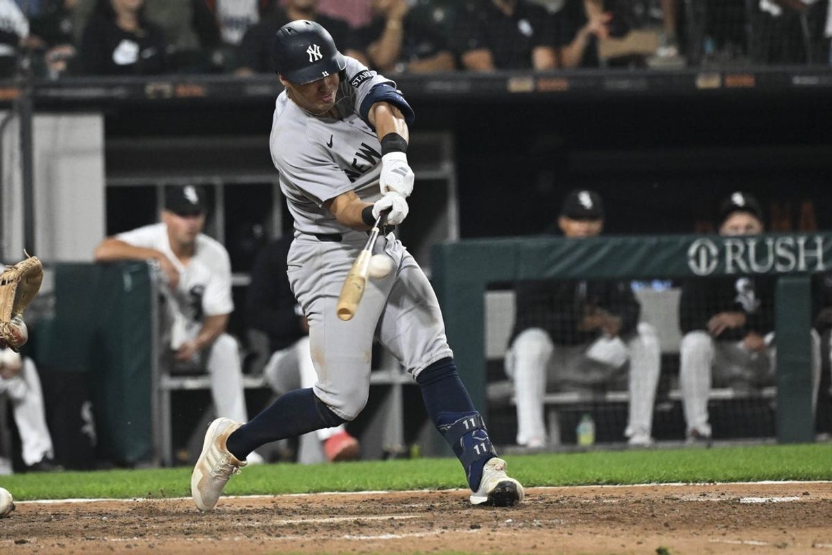 Aug 28, 2025; Chicago, Illinois, USA;  New York Yankees shortstop Anthony Volpe (11) hits an RBI sacrifice fly ball against the Chicago White Sox during the eighth inning at Rate Field. Mandatory Credit: Matt Marton-Imagn Images