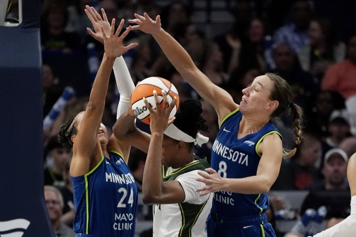 Aug 28, 2025; Minneapolis, Minnesota, USA; Minnesota Lynx forward Napheesa Collier (24) and forward Alanna Smith (8) defend against Seattle Storm center Dominique Malonga (14) in the third quarter at Target Center. Mandatory Credit: Bruce Kluckhohn-Imagn Images