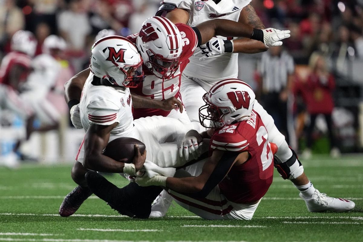 Aug 28, 2025; Madison, Wisconsin, USA;  Wisconsin Badgers defensive lineman Brandon Lane Jr. (95) and linebacker Mason Reiger (22) sack Miami (OH) RedHawks quarterback Dequan Finn (1) during the second quarter at Camp Randall Stadium. Mandatory Credit: Jeff Hanisch-Imagn Images