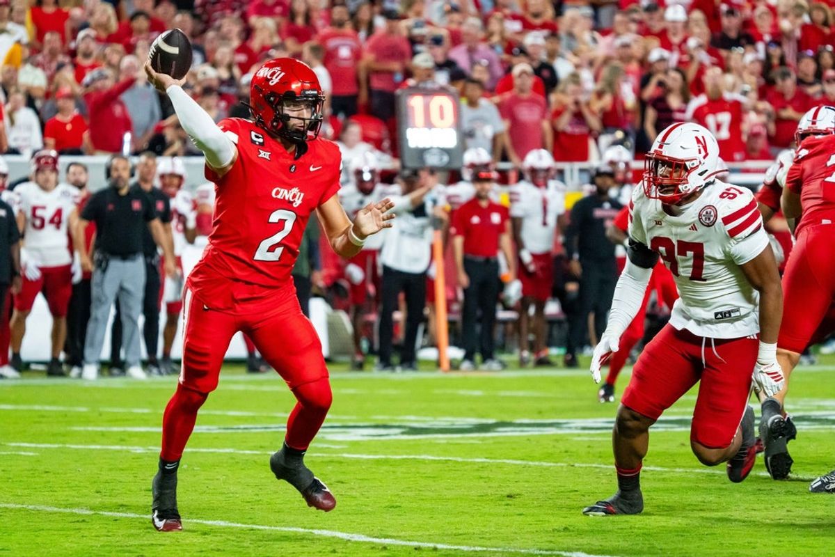 Aug 28, 2025; Kansas City, Missouri, USA; Cincinnati Bearcats quarterback Brendan Sorsby (2) passes against Nebraska Cornhuskers defensive lineman Keona Davis (97) during the second quarter at GEHA Field at Arrowhead Stadium. Mandatory Credit: Dylan Widger-Imagn Images