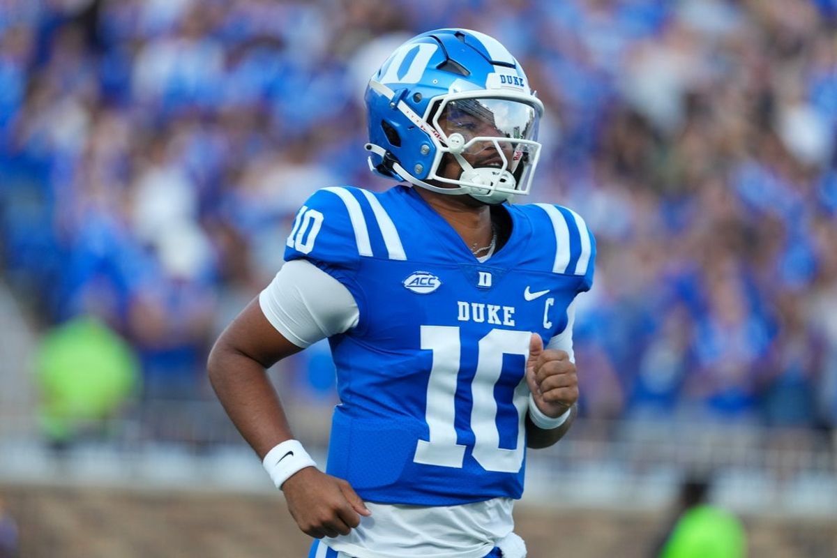 Aug 28, 2025; Durham, North Carolina, USA;  Duke Blue Devils quarterback Darian Mensah (10) comes running out onto the field before the start of the game against the Elon Phoenix at Wallace Wade Stadium. Mandatory Credit: James Guillory-Imagn Images