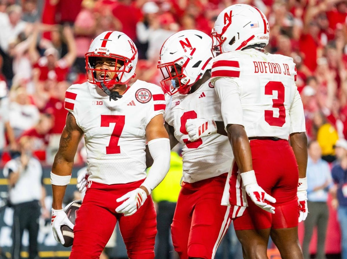 Aug 28, 2025; Kansas City, Missouri, USA; Nebraska Cornhuskers defensive back Malcolm Hartzog Jr. (7) celebrates with linebacker Vincent Shavers Jr. (9) and defensive back Marques Buford Jr. (3) after an interception against the Cincinnati Bearcats during the fourth quarter at GEHA Field at Arrowhead Stadium. Mandatory Credit: Dylan Widger-Imagn Images