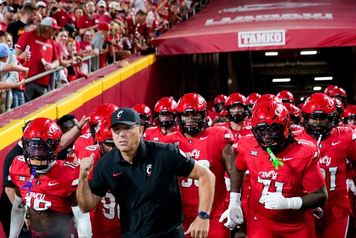 The Cincinnati Bearcats run out the tunnel to face off against the Nebraska Cornhuskers at the Kansas City Classic, Aug. 28, 2025, at Arrowhead Stadium in Kansas City, Mo.