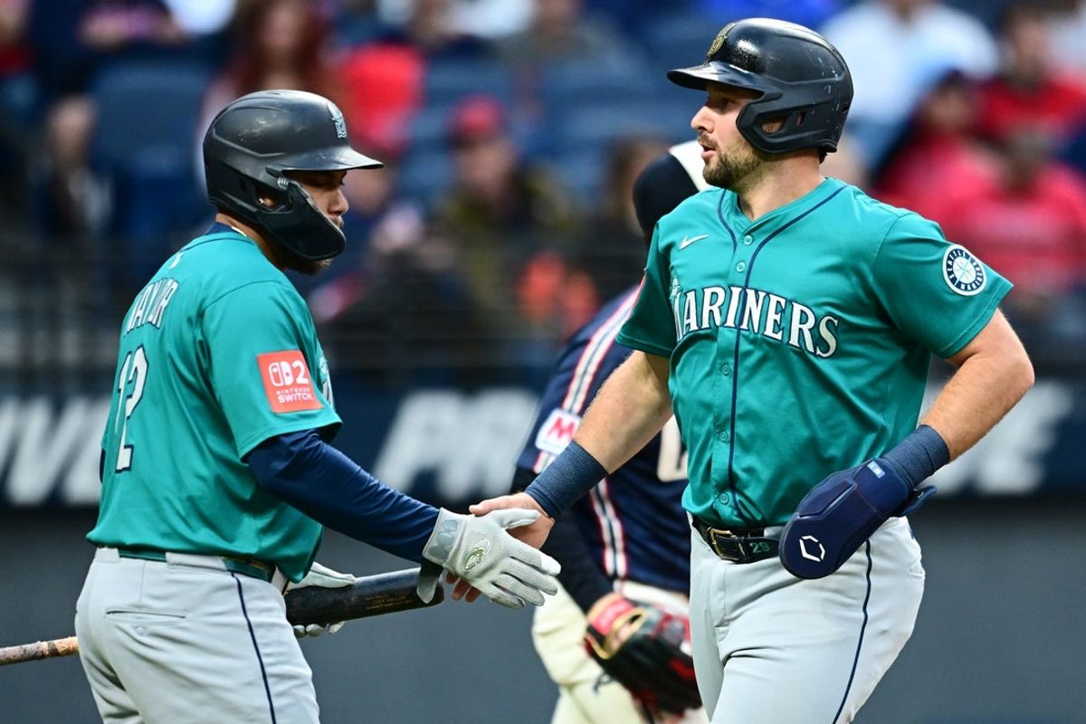 Aug 29, 2025; Cleveland, Ohio, USA; Seattle Mariners catcher Cal Raleigh (29) celebrates with first baseman Josh Naylor (12) after scoring against the Cleveland Guardians during the first inning at Progressive Field. Mandatory Credit: Ken Blaze-Imagn Images