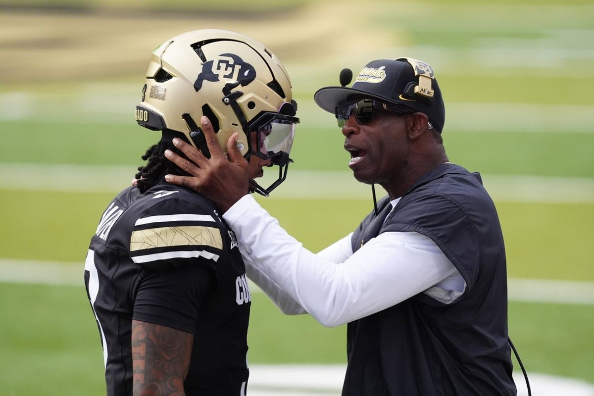 Aug 29, 2025; Boulder, Colorado, USA; Colorado Buffaloes head coach Deion Sanders congratulates Colorado Buffaloes quarterback Kaidon Salter (3) following a touchdown pass in the first quarter against the Georgia Tech Yellow Jackets at Folsom Field. Mandatory Credit: Ron Chenoy-Imagn Images