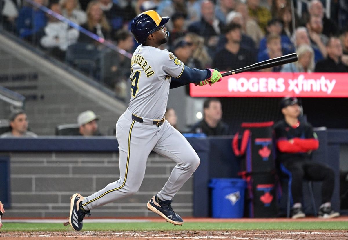 Aug 29, 2025; Toronto, Ontario, CAN;  Milwaukee Brewers shortstop Andruw Monasterio (14) hits a solo home run against the Toronto Blue Jays in the sixth inning at Rogers Centre. Mandatory Credit: Dan Hamilton-Imagn Images