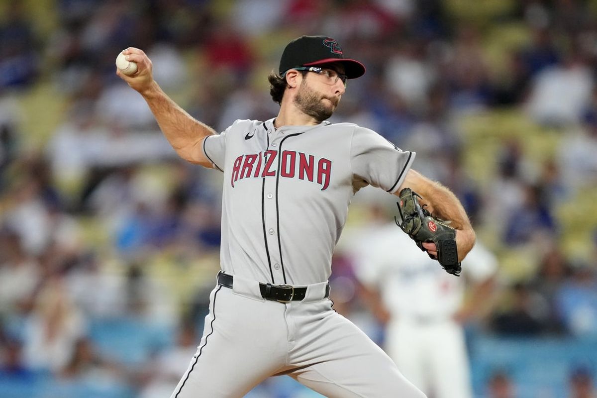 Aug 29, 2025; Los Angeles, California, USA; Arizona Diamondbacks starting pitcher Zac Gallen (23) pitches in the first inning against the Los Angeles Dodgers at Dodger Stadium. Mandatory Credit: Kirby Lee-Imagn Images