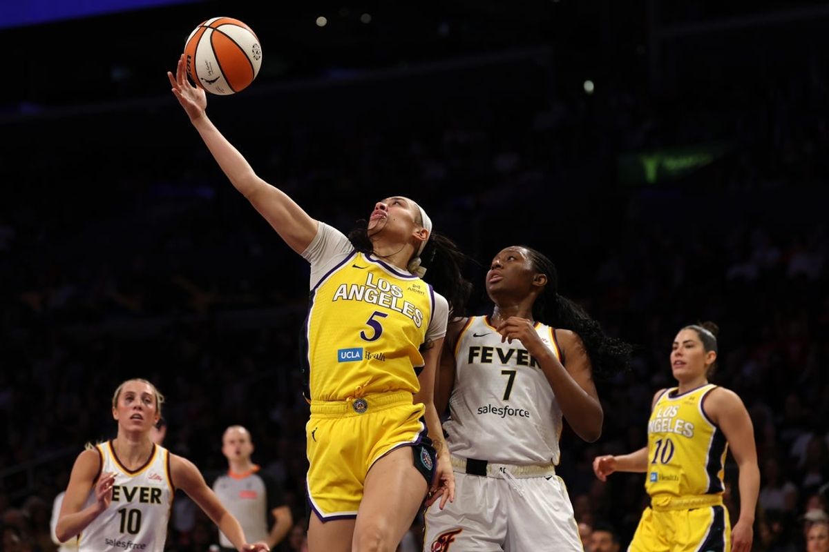 Aug 29, 2025; Los Angeles, California, USA;  Los Angeles Sparks forward Dearica Hamby (5) rebounds a ball against Indiana Fever forward Aliyah Boston (7) during the second quarter at Crypto.com Arena. Mandatory Credit: Kiyoshi Mio-Imagn Images