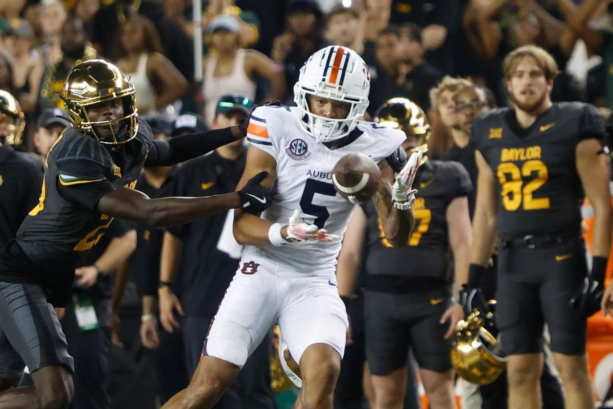 Aug 29, 2025; Waco, Texas, USA;  Auburn Tigers wide receiver Horatio Fields (5) catchesa pass against Baylor Bears safety Cameren Jenkins (23) during the second half at McLane Stadium. Mandatory Credit: Chris Jones-Imagn Images