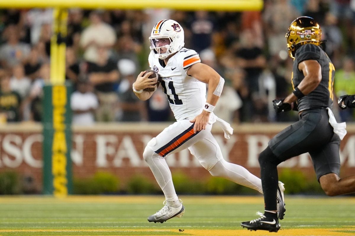 Aug 29, 2025; Waco, Texas, USA;  Auburn Tigers quarterback Jackson Arnold (11) runs the ball as Baylor Bears safety Tyler Turner (17) defends during the first half at McLane Stadium. Mandatory Credit: Chris Jones-Imagn Images
