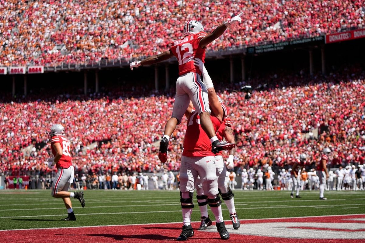 Ohio State Buckeyes running back CJ Donaldson (12) celebrates a touchdown with offensive lineman Carson Hinzman (75) during the first half of the NCAA football game against the Texas Longhorns at Ohio Stadium on Aug. 30, 2025.
