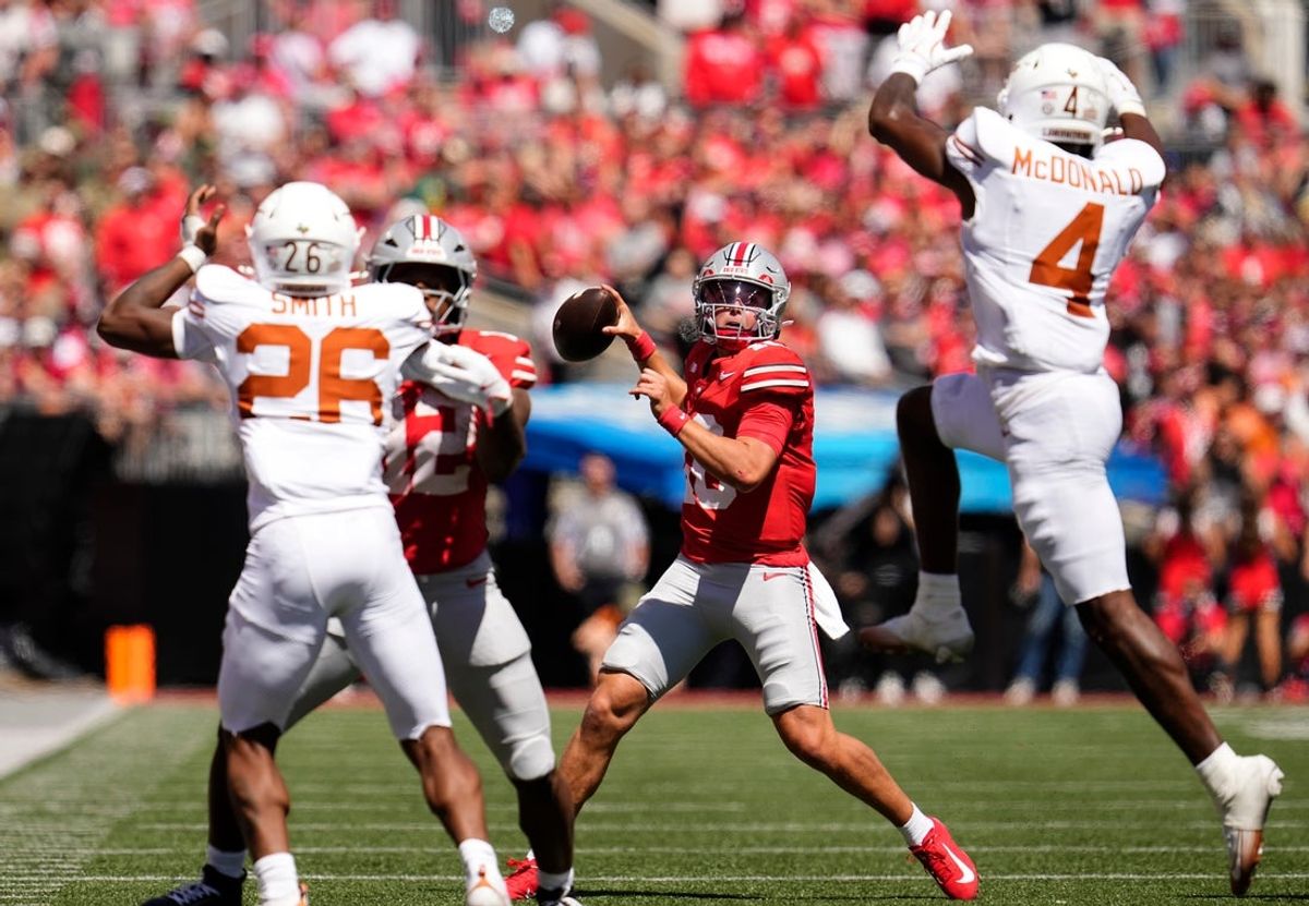Ohio State Buckeyes quarterback Julian Sayin (10) throws past Texas Longhorns defensive back Jelani McDonald (4) during the first half of the NCAA football game at Ohio Stadium on Aug. 30, 2025.
