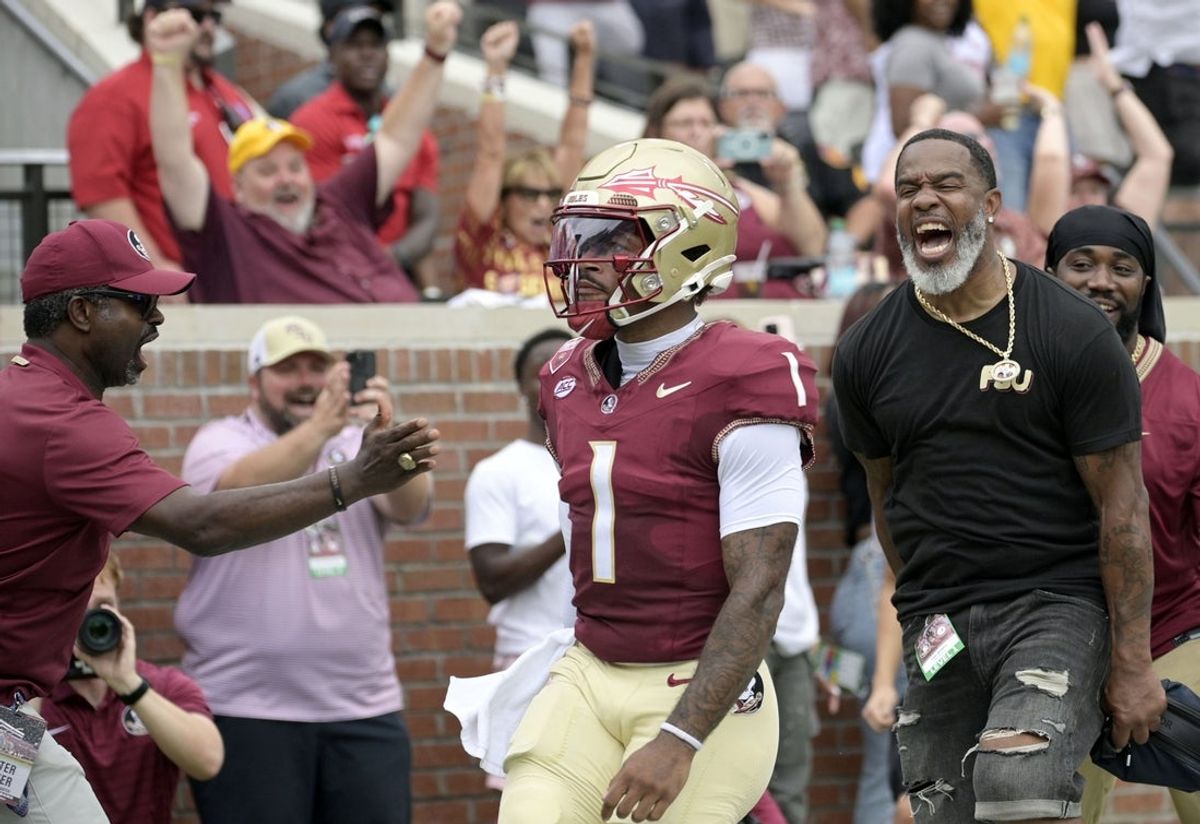 Aug 30, 2025; Tallahassee, Florida, USA; Florida State Seminoles quarterback Tommy Castellanos (1) celebrates with Peter Warrick (back) after scoring a touchdown against the Alabama Crimson Tide during the first half at Doak S. Campbell Stadium. Mandatory Credit: Melina Myers-Imagn Images