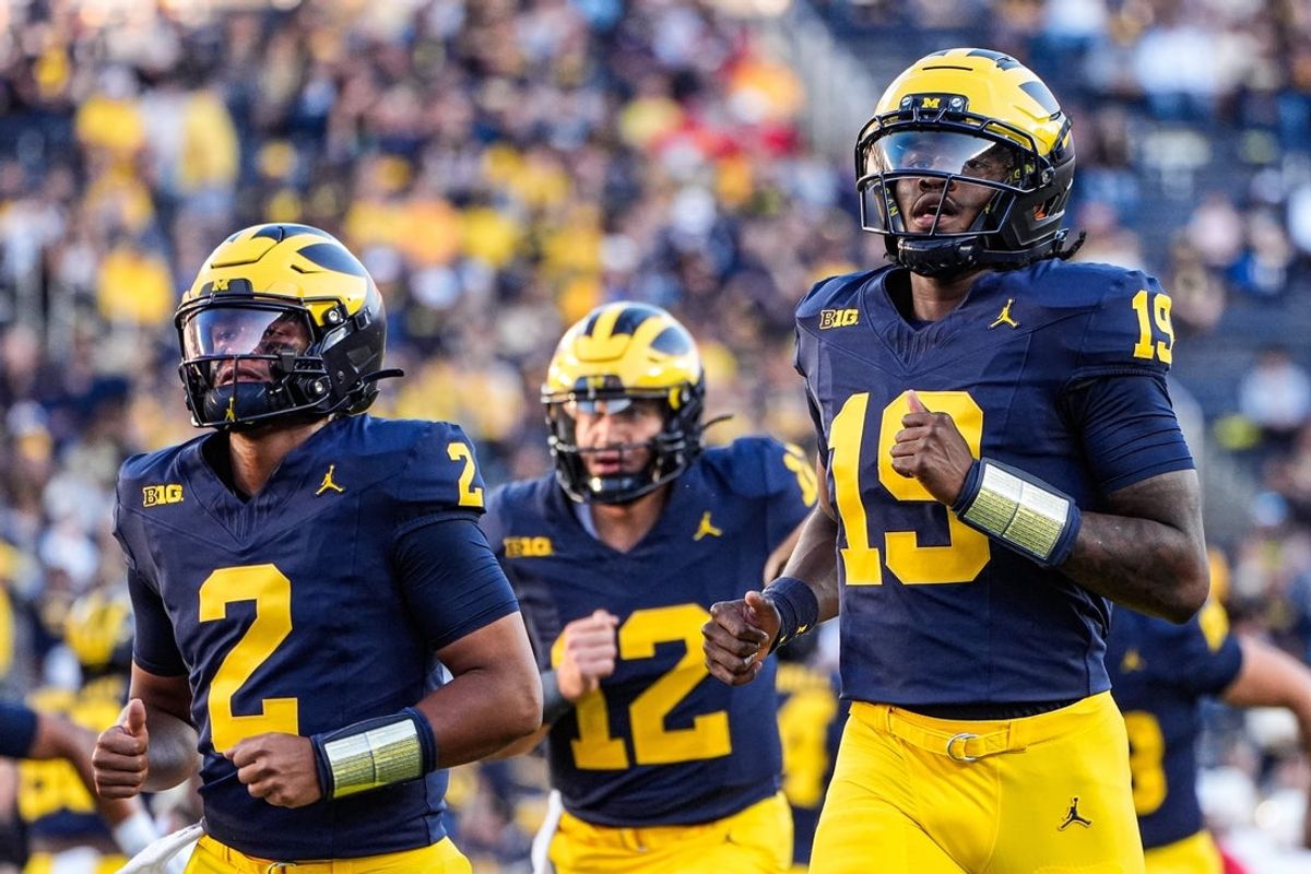 Michigan quarterback Bryce Underwood (19), right, and quarterback Jadyn Davis (2), left, warm up ahead of the New Mexico game at Michigan Stadium in Ann Arbor on Saturday, August 30, 2025.