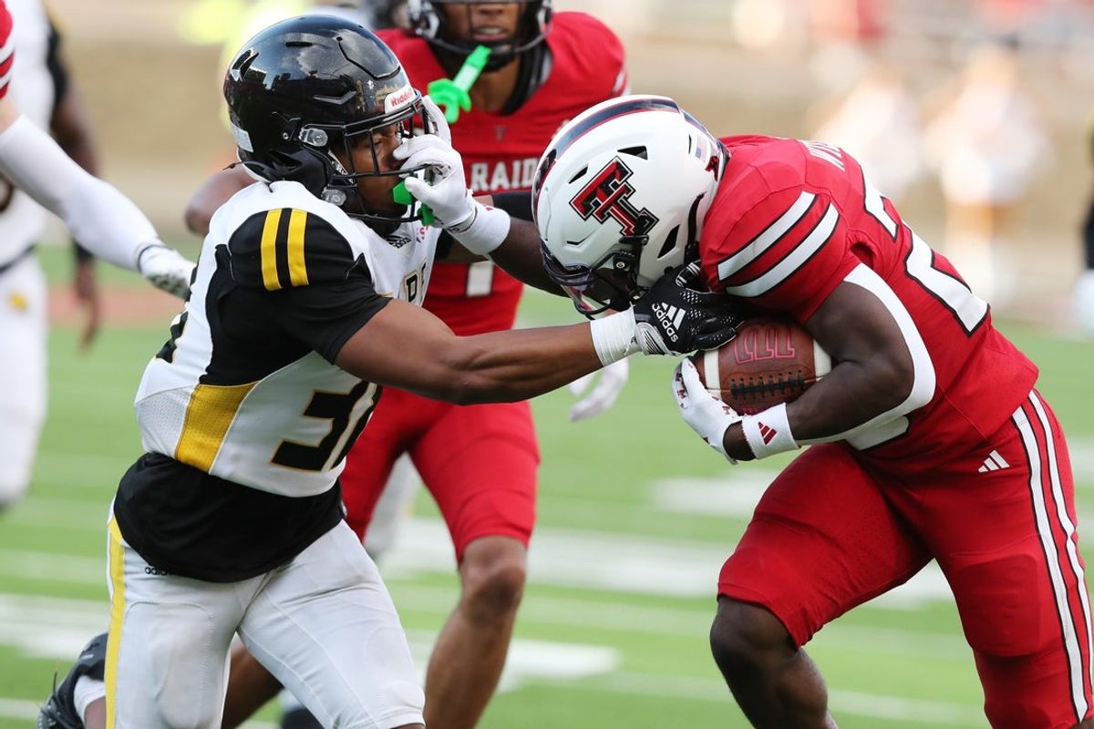 Aug 30, 2025; Lubbock, Texas, USA;  Texas Tech Red Raiders running back J’Koby Williams (20) rushes against Arkansas-Pine Bluff Golden Lions defensive safety Na’il Johnson (38) in the first half at Jones AT&T Stadium. Mandatory Credit: Michael C. Johnson-Imagn Images