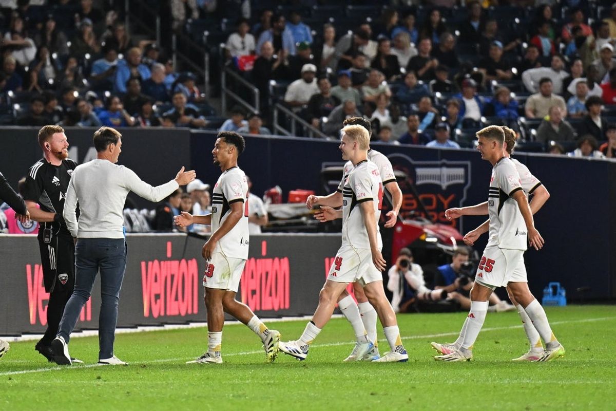 Aug 30, 2025; New York, New York, USA; D.C. United midfielder Brandon Servania (23) celebrates a goal with D.C. United head coach Rene Weiler during the first half at Yankee Stadium. Mandatory Credit: Mark Smith-Imagn Images