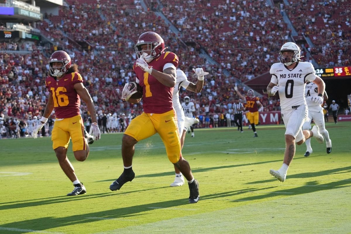 Aug 30, 2025; Los Angeles, California, USA; Southern California Trojans running back Eli Sanders (1) is pursued by Missouri State Bears safety J.J. O'Neal (16) and safety Maguire Neal (0) on a 73-yard touchdown reception in the first half at United Airlines Field at Los Angeles Memorial Coliseum. Mandatory Credit: Kirby Lee-Imagn Images