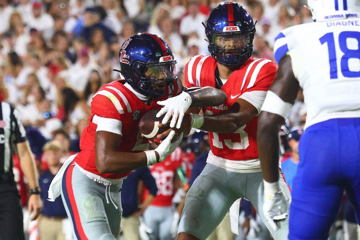 Aug 30, 2025; Oxford, Mississippi, USA; Mississippi Rebels quarterback Austin Simmons (13) hands the ball off to running back Kewan Lacy (5) during the second quarter against the Georgia State Panthers at Vaught-Hemingway Stadium. Mandatory Credit: Petre Thomas-Imagn Images