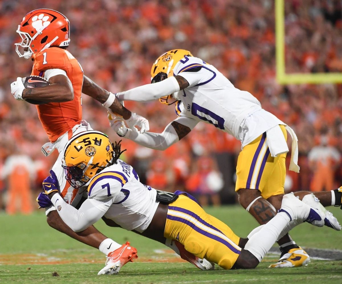 Clemson Tigers wide receiver T.J. Moore (1) is tackled by LSU Tigers linebacker Harold Perkins Jr. (7) and LSU Tigers safety Tamarcus Cooley (0) Saturday, Aug. 30, 2025 during the NCAA football game at Memorial Stadium in Clemson, South Carolina.