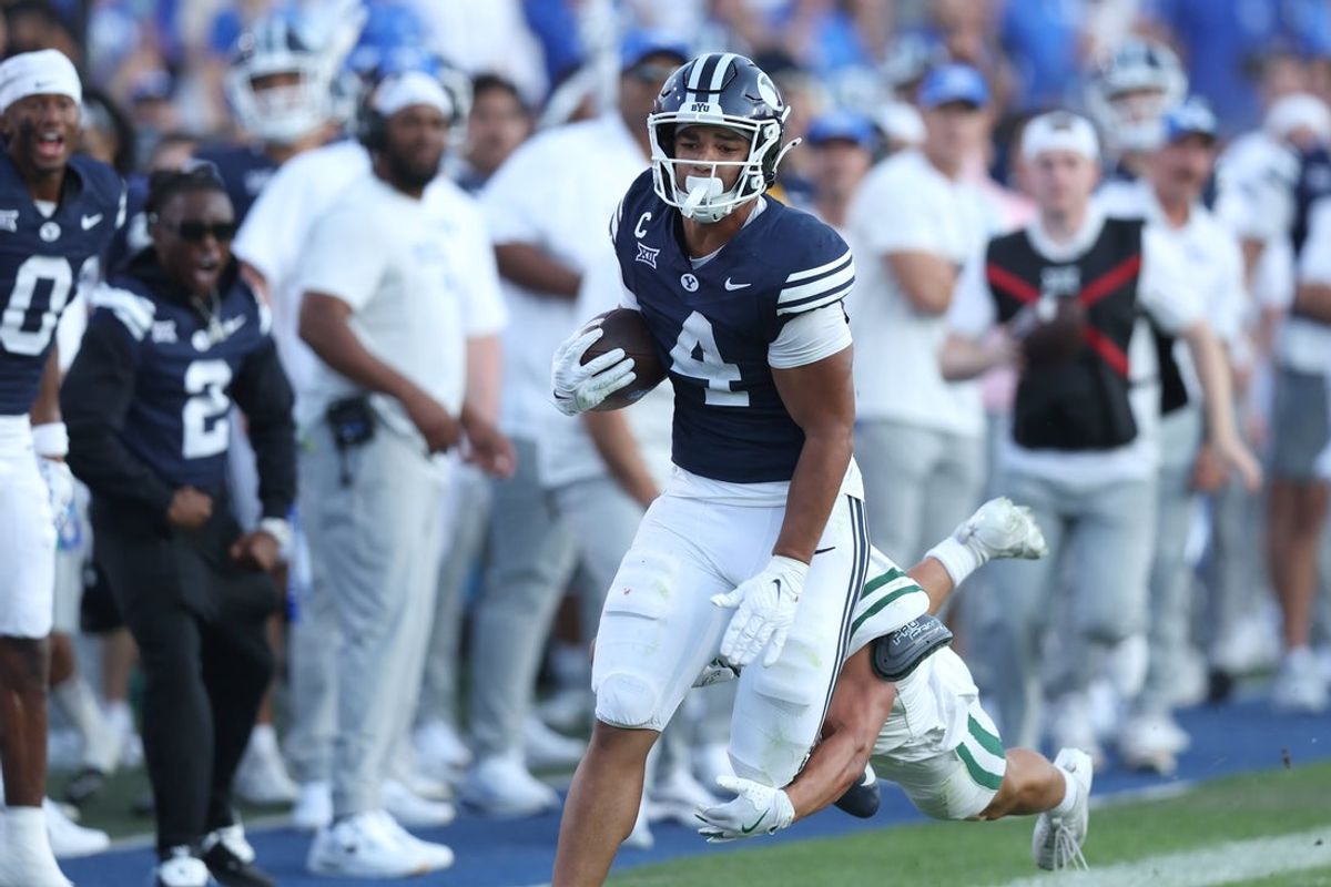 Aug 30, 2025; Provo, Utah, USA; Brigham Young Cougars running back LJ Martin (4) runs the ball against Portland State Vikings linebacker Lonnie Burt (40) during the second quarter at LaVell Edwards Stadium. Mandatory Credit: Rob Gray-Imagn Images