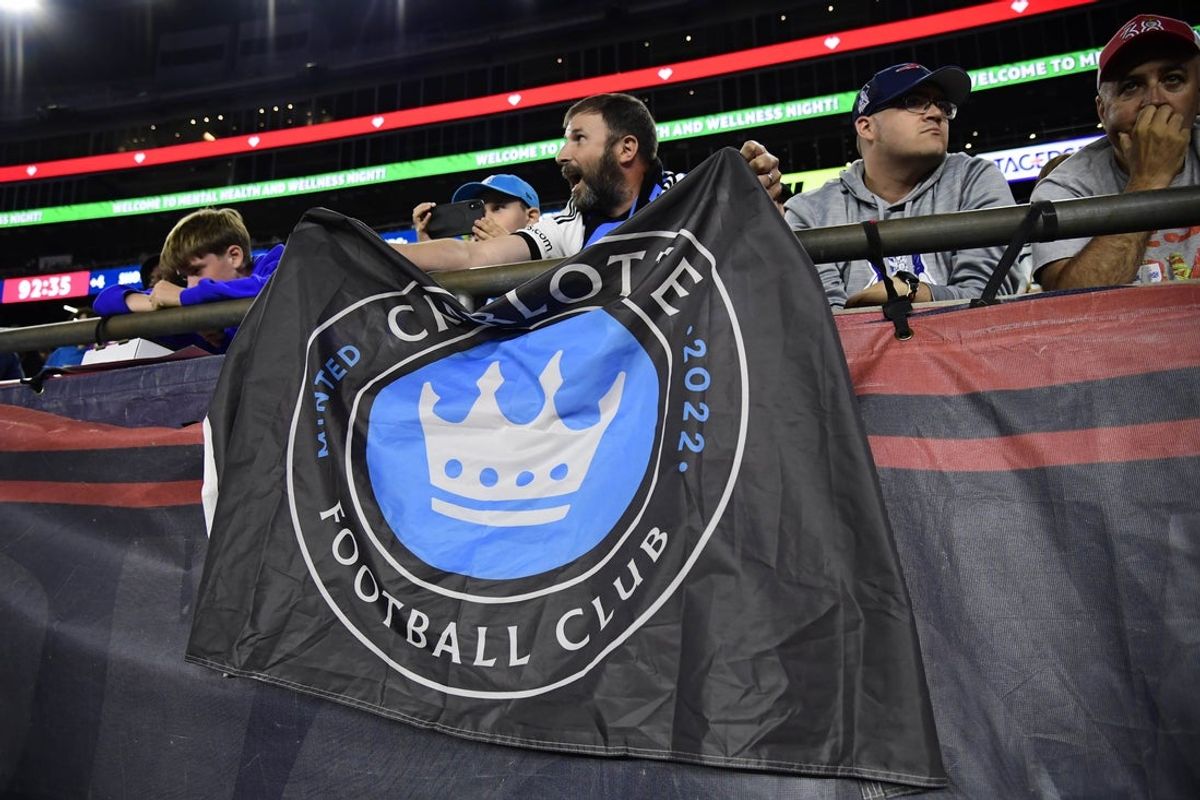 Aug 30, 2025; Foxborough, Massachusetts, USA;  A fan holds a banner during the second half in a match between the New England Revolution and Charlotte FC at Gillette Stadium. Mandatory Credit: Bob DeChiara-Imagn Images