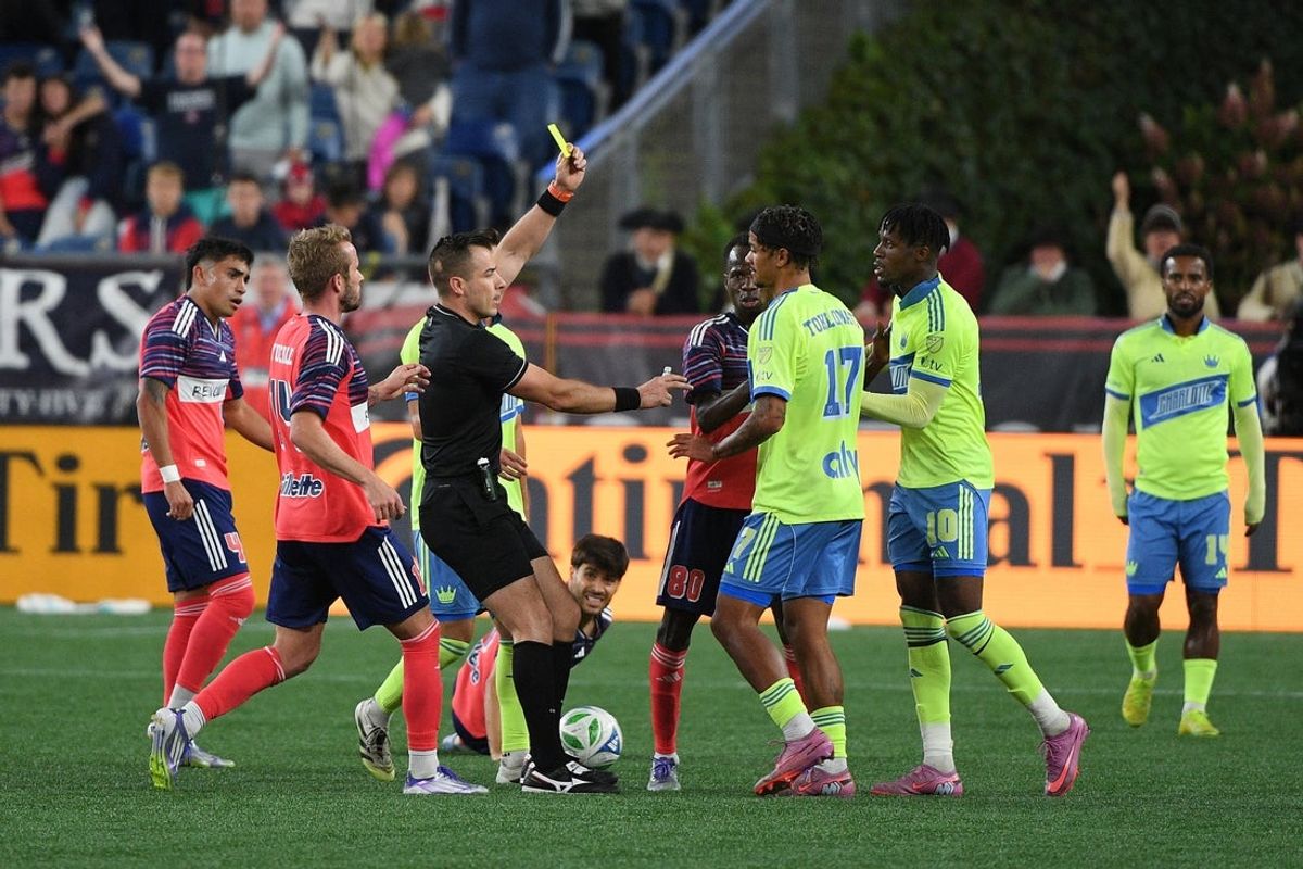 Aug 30, 2025; Foxborough, Massachusetts, USA; A yellow card is issued to Charlotte FC forward Idan Toklomati (17) during the second half against the New England Revolution at Gillette Stadium. Mandatory Credit: Bob DeChiara-Imagn Images