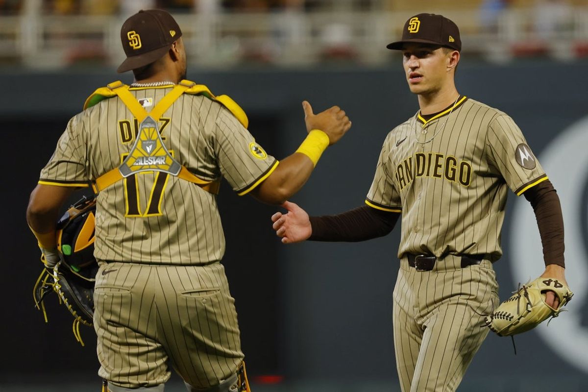 Aug 30, 2025; Minneapolis, Minnesota, USA; San Diego Padres catcher Elias Diaz (17) and relief pitcher Alek Jacob (37) celebrate the win over the Minnesota Twins at Target Field. Mandatory Credit: Bruce Kluckhohn-Imagn Images