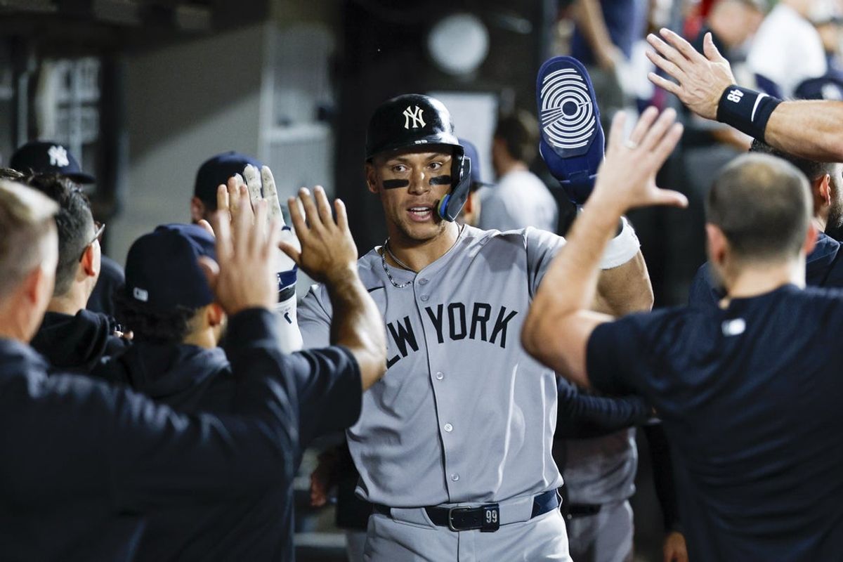 Aug 30, 2025; Chicago, Illinois, USA; New York Yankees designated hitter Aaron Judge (99) celebrates with teammates in the dugout after scoring against the Chicago White Sox during the 11th inning at Rate Field. Mandatory Credit: Kamil Krzaczynski-Imagn Images