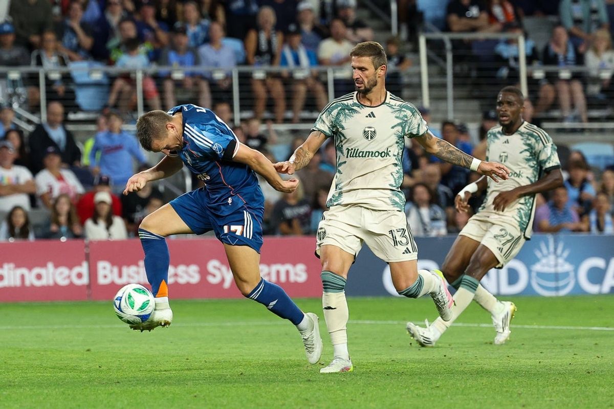 Aug 30, 2025; Saint Paul, Minnesota, USA; Minnesota United midfielder Robin Lod (17) scores a goal as Portland Timbers defender Dario Zuparic (13) defends during the second half at Allianz Field. Mandatory Credit: Matt Krohn-Imagn Images