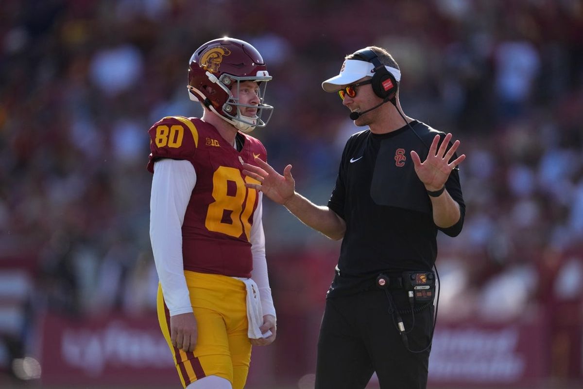 Aug 30, 2025; Los Angeles, California, USA; Southern California Trojans head coach Lincoln (right) talks with Southern California Trojans punter Sam Johnson (80) in the first half against the Missouri State Bears at United Airlines Field at Los Angeles Memorial Coliseum. Mandatory Credit: Kirby Lee-Imagn Images