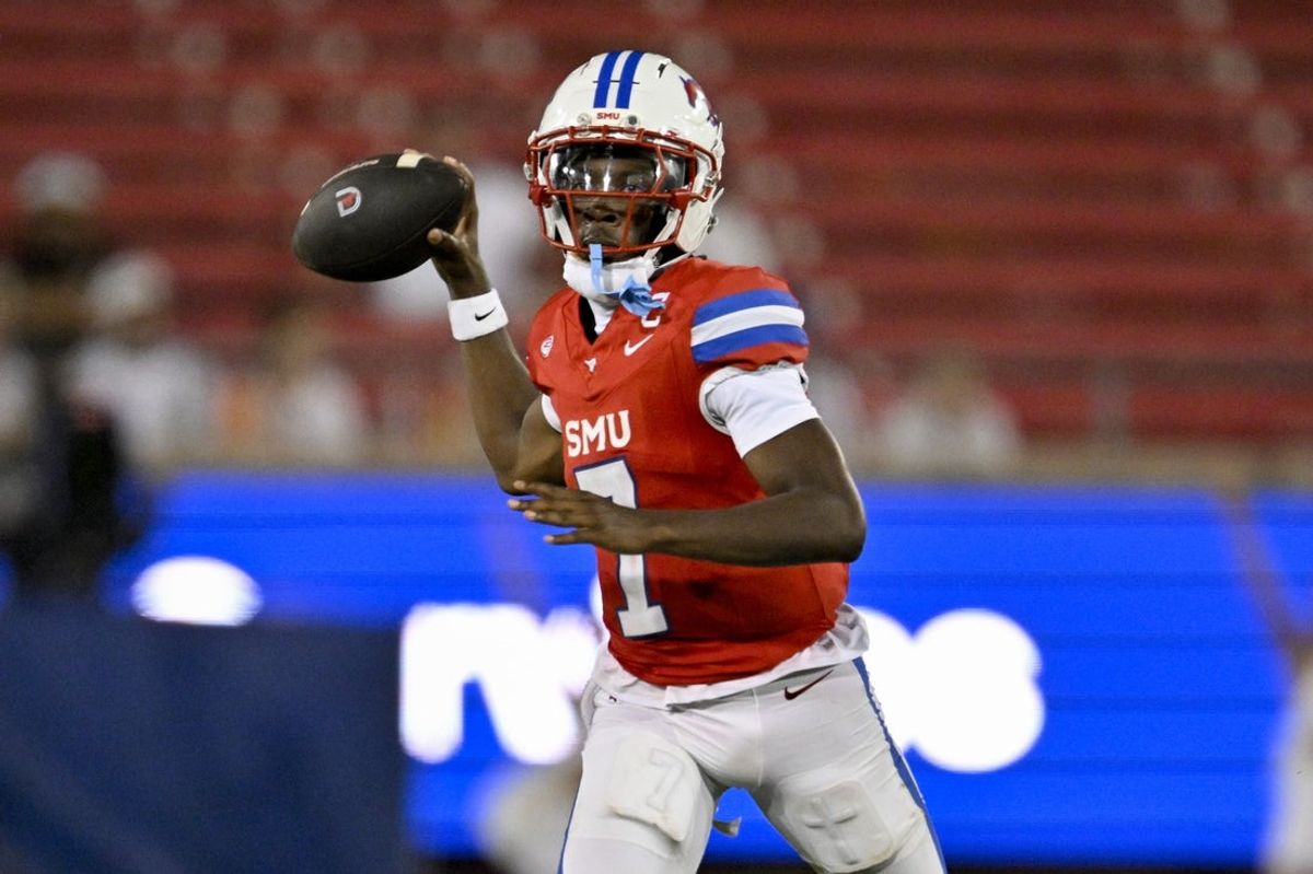 Aug 30, 2025; Dallas, Texas, USA; Southern Methodist Mustangs quarterback Kevin Jennings (7) passes the ball for a touchdown against the East Texas A&M Lions during the second half at Gerald J. Ford Stadium. Mandatory Credit: Jerome Miron-Imagn Images