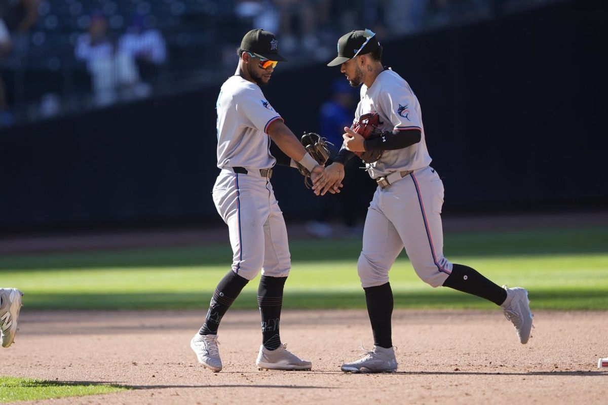 Aug 31, 2025; New York City, New York, USA; Miami Marlins shortstop Otto Lopex (6) and left fielder Heriberto Hernandez (64) slap hands to celebrate the victory against the New York Mets after the ninth inning at Citi Field. Mandatory Credit: Gregory Fisher-Imagn Images