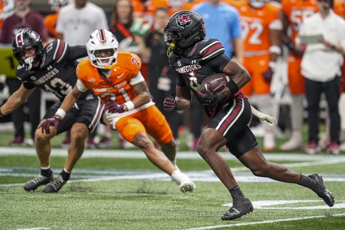 Aug 31, 2025; Atlanta, Georgia, USA; South Carolina Gamecocks defensive back Vicari Swain (4) returns a punt for a touchdown against the Virginia Tech Hokies during the second half at Mercedes-Benz Stadium. Mandatory Credit: Dale Zanine-Imagn Images