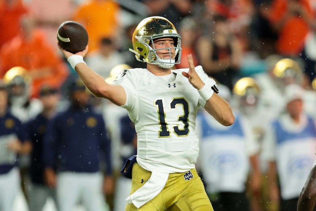 Aug 31, 2025; Miami Gardens, Florida, USA; Notre Dame Fighting Irish quarterback CJ Carr (13) drops back to pass against the Miami Hurricanes during the first quarter at Hard Rock Stadium. Mandatory Credit: Sam Navarro-Imagn Images