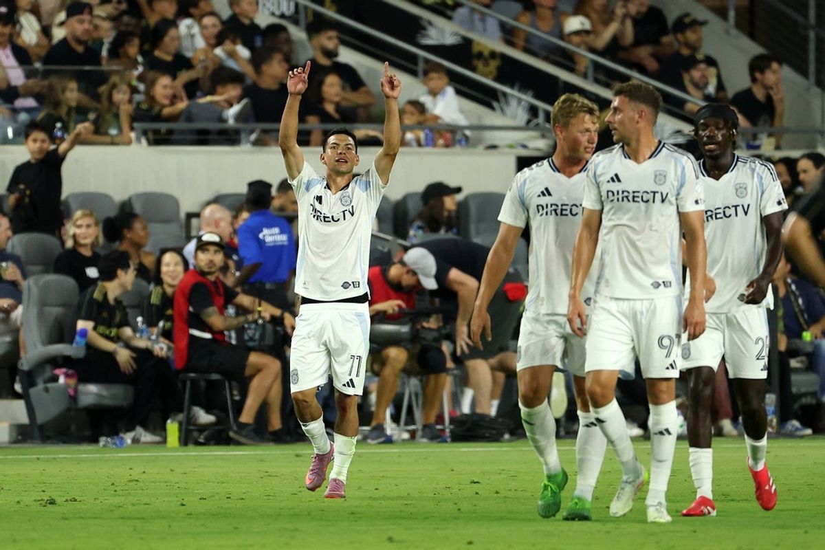 Aug 31, 2025; Los Angeles, California, USA;  San Diego FC forward Hirving Lozano (11, left) celebrates after scoring a goal during the first half against LAFC at BMO Stadium. Mandatory Credit: Kiyoshi Mio-Imagn Images