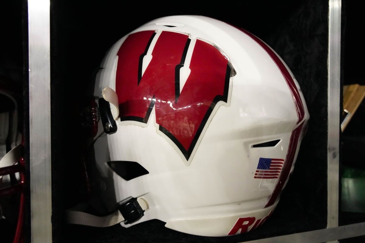 Aug 28, 2025; Madison, Wisconsin, USA;  General view of a Wisconsin Badgers football helmet on the sidelines during the game against the Miami (OH) RedHawks at Camp Randall Stadium. Mandatory Credit: Jeff Hanisch-Imagn Images