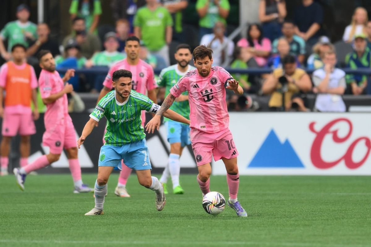 Aug 31, 2025; Seattle, Washington, USA; Inter Miami CF forward Lionel Messi (10) plays the ball while defended by Seattle Sounders FC midfielder Cristian Roldan (7) during the second half at Lumen Field. Mandatory Credit: Steven Bisig-Imagn Images