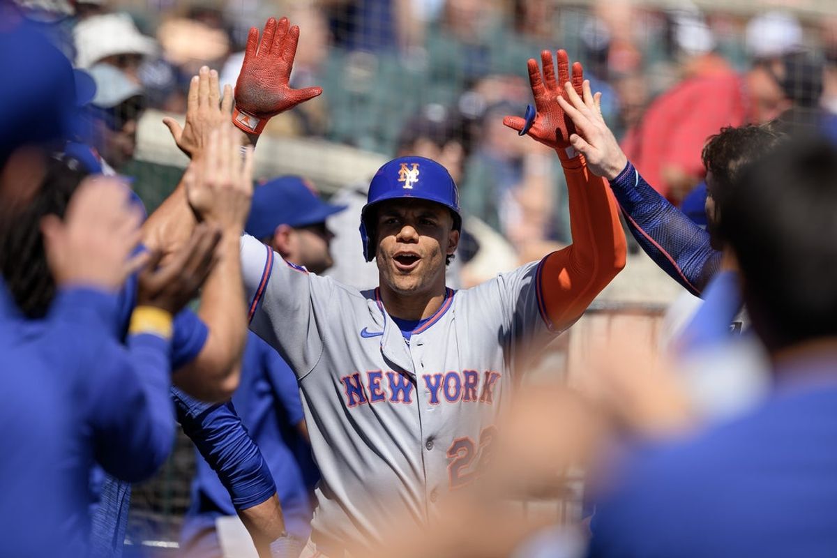 Sep 1, 2025; Detroit, Michigan, USA;  New York Mets right fielder Juan Soto (22) celebrates in the dugout after hitting a grand slam home run against the Detroit Tigers in the fourth inning at Comerica Park. Mandatory Credit: Lon Horwedel-Imagn Images