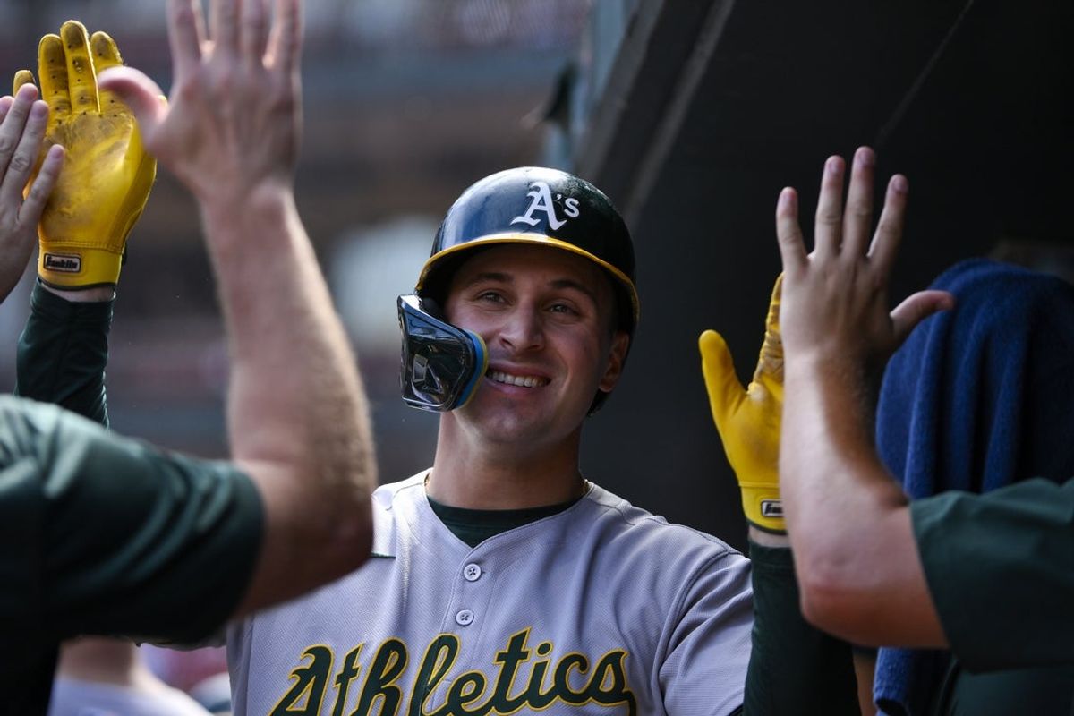 Sep 1, 2025; St. Louis, Missouri, USA;  Athletics right fielder JJ Bleday (33) is congratulated by teammates after hitting a two run home run against the St. Louis Cardinals during the fourth inning at Busch Stadium. Mandatory Credit: Jeff Curry-Imagn Images