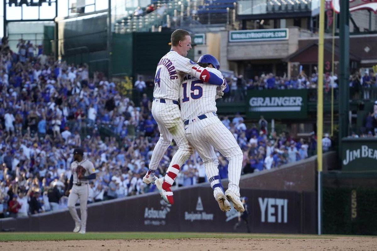 Sep 1, 2025; Chicago, Illinois, USA; Chicago Cubs catcher Carson Kelly (15) celebrates his game winning single with outfielder Pete Crow-Armstrong (4) against the Atlanta Braves during the tenth inning at Wrigley Field. Mandatory Credit: David Banks-Imagn Images