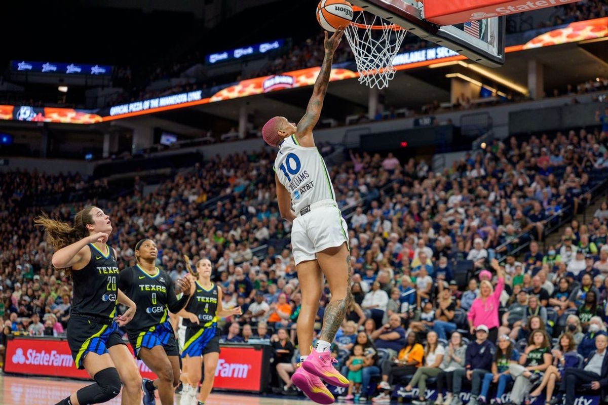 Sep 1, 2025; Minneapolis, Minnesota, USA; Minnesota Lynx guard Courtney Williams (10) makes the layup past the defenses of Dallas Wings forward Maddy Siegrist (20) and forward Amy Okonkwo (0) in the first quarter at Target Center. Mandatory Credit: Matt Blewett-Imagn Images