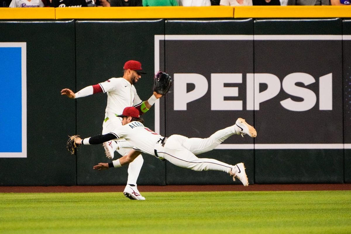 Sep 1, 2025; Phoenix, Arizona, USA; Arizona Diamondbacks centerfielder Blaze Alexander (9) and Arizona Diamondbacks outfielder Lourdes Gurriel Jr. (12) collide in the outfield. Gurriel Jr. was taken off by cart in the sixth inning during the game between the Texas Rangers and Arizona Diamondbacks at Chase Field. Mandatory Credit: Arianna Grainey-Imagn Images