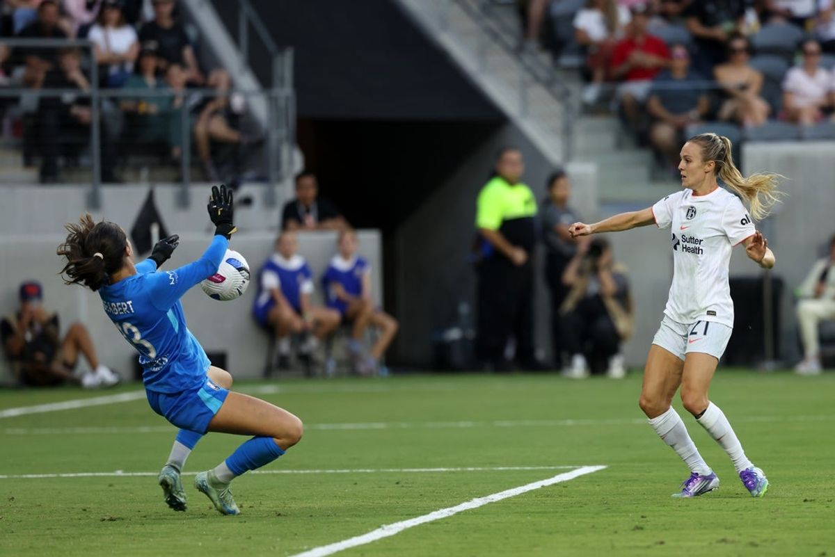 Sep 1, 2025; Los Angeles, California, USA;  Bay FC forward Rachel Hill (21) shoots the ball against Angel City FC goalkeeper Hannah Seabert (13) during the first half at BMO Stadium. Mandatory Credit: Kiyoshi Mio-Imagn Images
