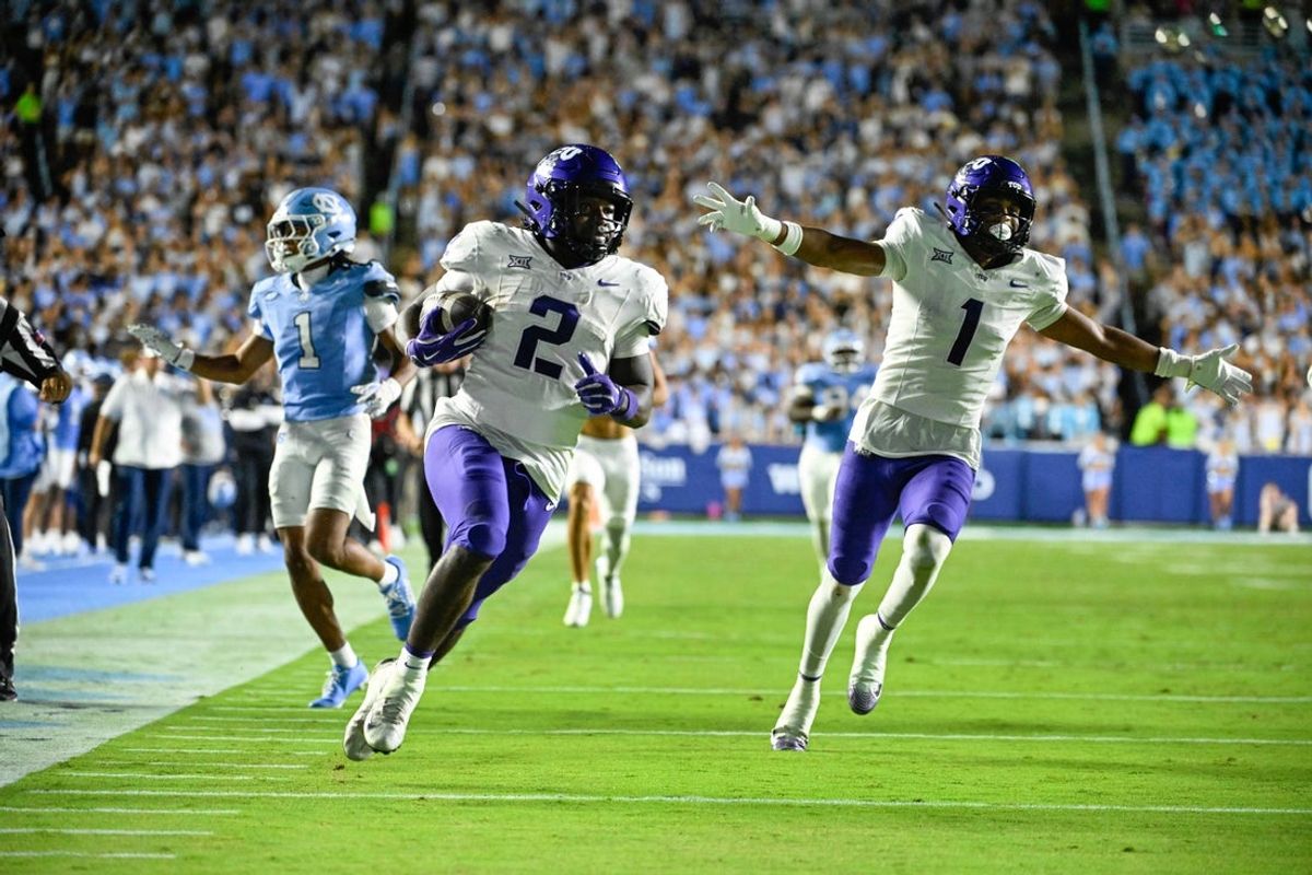 Sep 1, 2025; Chapel Hill, North Carolina, USA; TCU Horned Frogs running back Kevorian Barnes (2) scores a touchdown as safety Austin Jordan (1) celebrates and North Carolina Tar Heels defensive back Thaddeus Dixon (1) defends in the third quarter at Kenan Stadium. Mandatory Credit: Bob Donnan-Imagn Images
