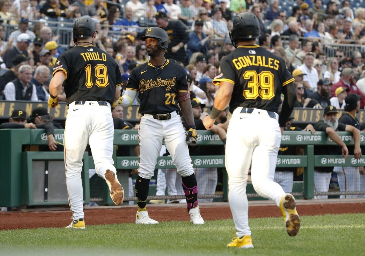 Sep 2, 2025; Pittsburgh, Pennsylvania, USA; Pittsburgh Pirates designated hitter Andrew McCutchen (22) congratulates shortstop Jared Triolo (19) and second baseman Nick Gonzales (39) after both players scored runs  against the Los Angeles Dodgers during the first inning at PNC Park. Mandatory Credit: Charles LeClaire-Imagn Images