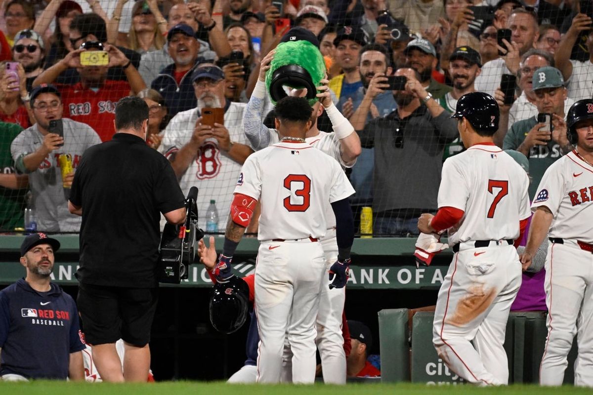Sep 2, 2025; Boston, Massachusetts, USA;  Boston Red Sox center fielder Ceddanne Rafaela (3) has a Wally hat placed on his head after hitting a two run home run against the Cleveland Guardians during the sixth inning at Fenway Park. Mandatory Credit: Eric Canha-Imagn Images